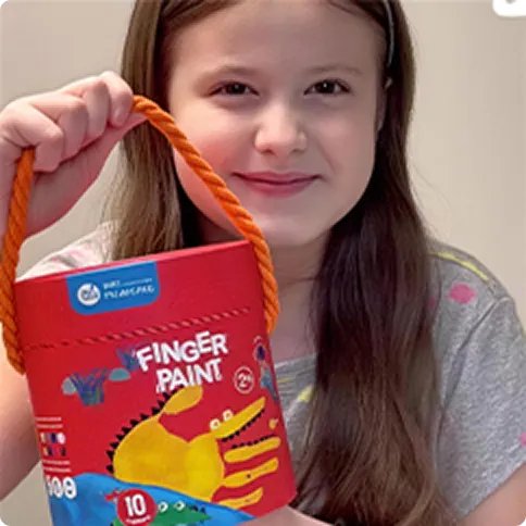 Child holding a finger paint bag