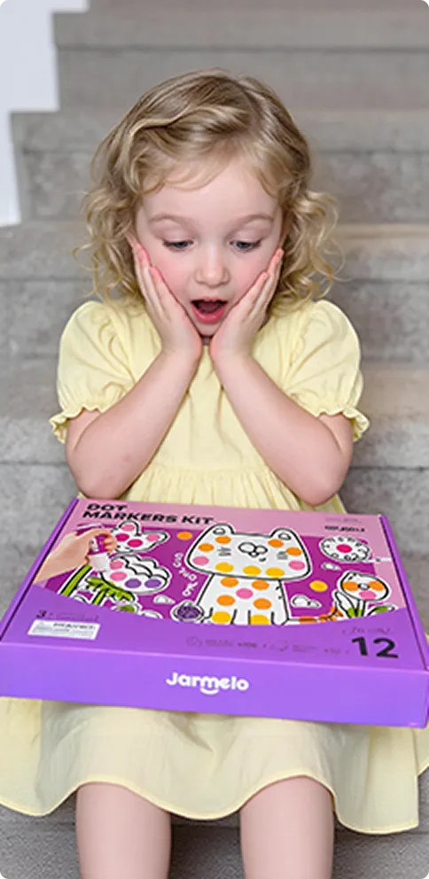 Child sitting on stairs with a craft kit box