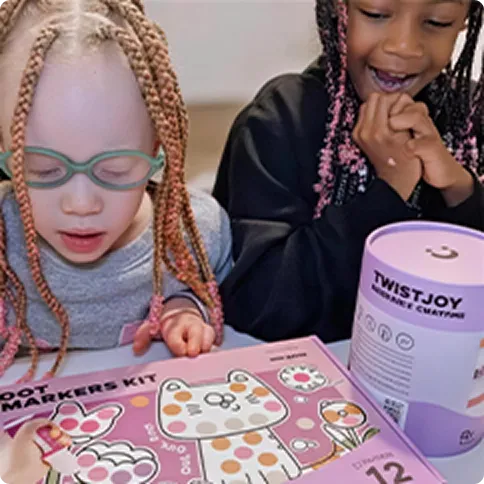 Two children playing with a clay kit and storage box